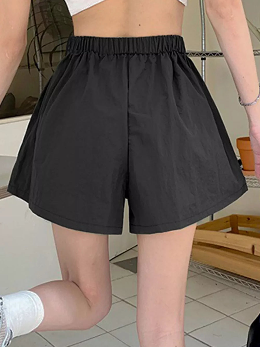 Black cargo shorts with elastic waistband and adjustable drawstring detail