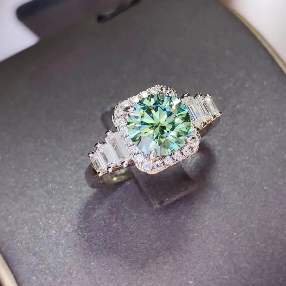 Emerald halo ring with baguette side stones in silver.