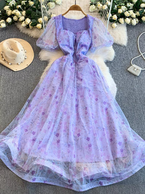 Purple floral maxi dress with sweetheart neckline, puff sleeves, and glitter tulle overlay.