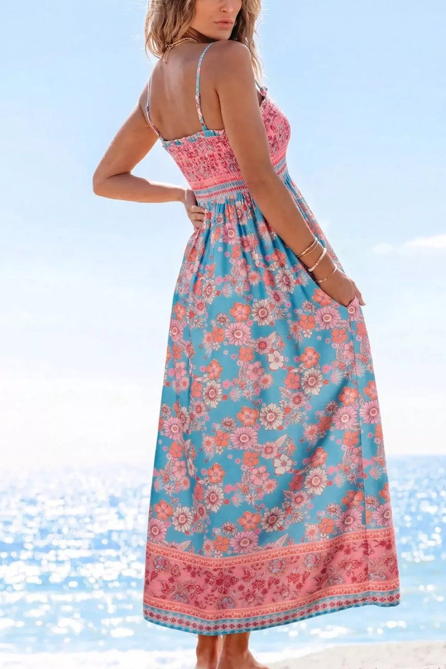Bohemian floral maxi dress with smocked pink bodice and blue floral skirt.