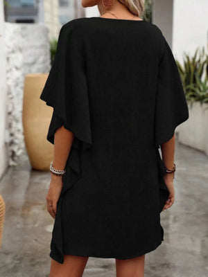 Black V-neck mini dress with flowy sleeves and ruffled hem detail.