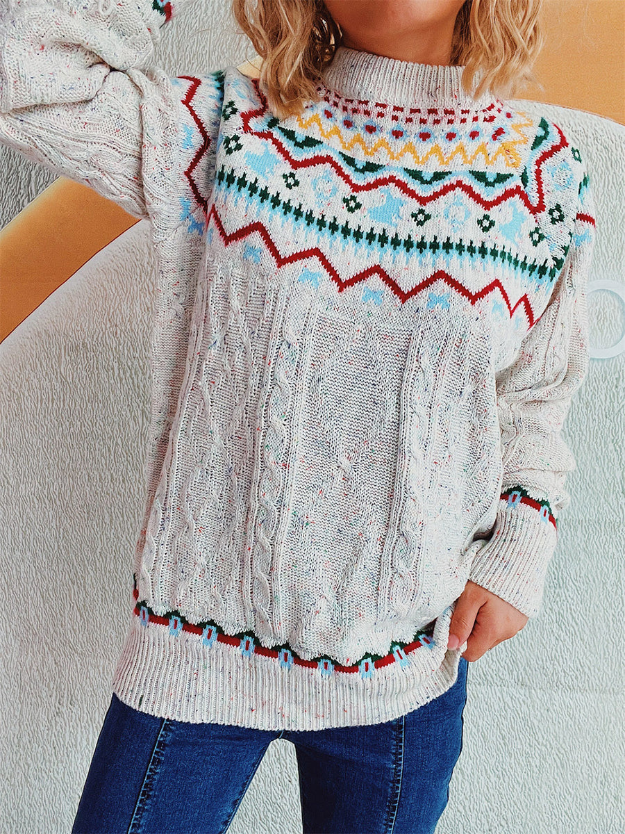 Beige cable knit turtleneck sweater with Fair Isle pattern and flecks of color.