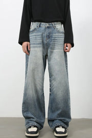 Baggy wash denim jeans in medium blue with a relaxed fit and distressed details.