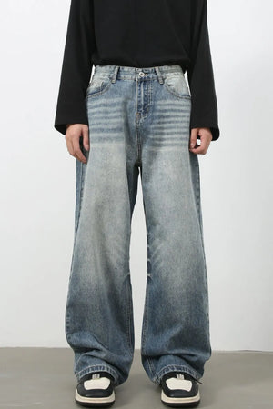 Baggy wash denim jeans in medium blue with a relaxed fit and distressed details.