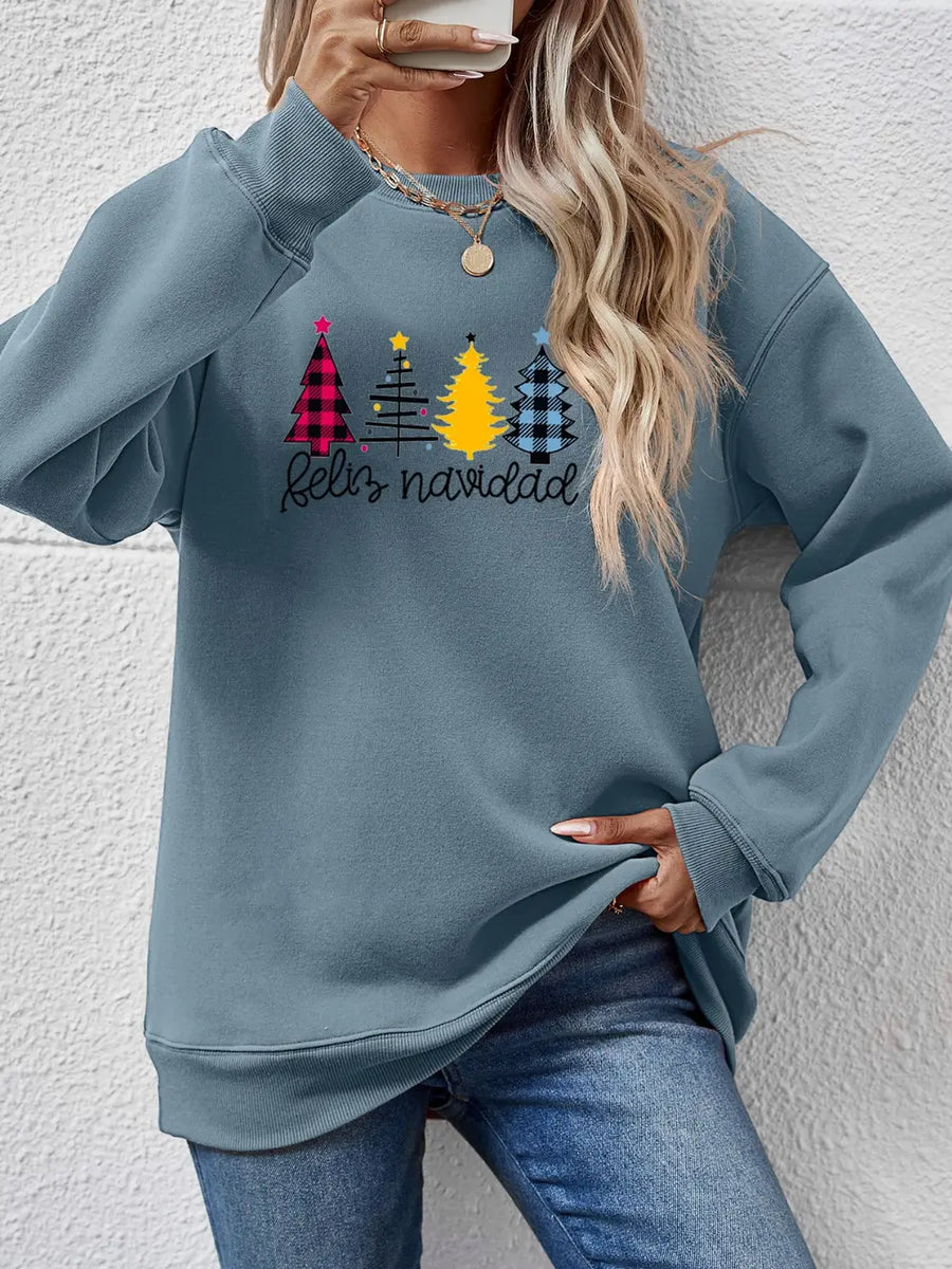 Feliz Navidad graphic crewneck sweatshirt in Misty Blue with plaid Christmas trees and script text.