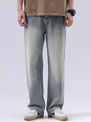 Men's blue vintage wash loose fit cotton jeans with faded details.