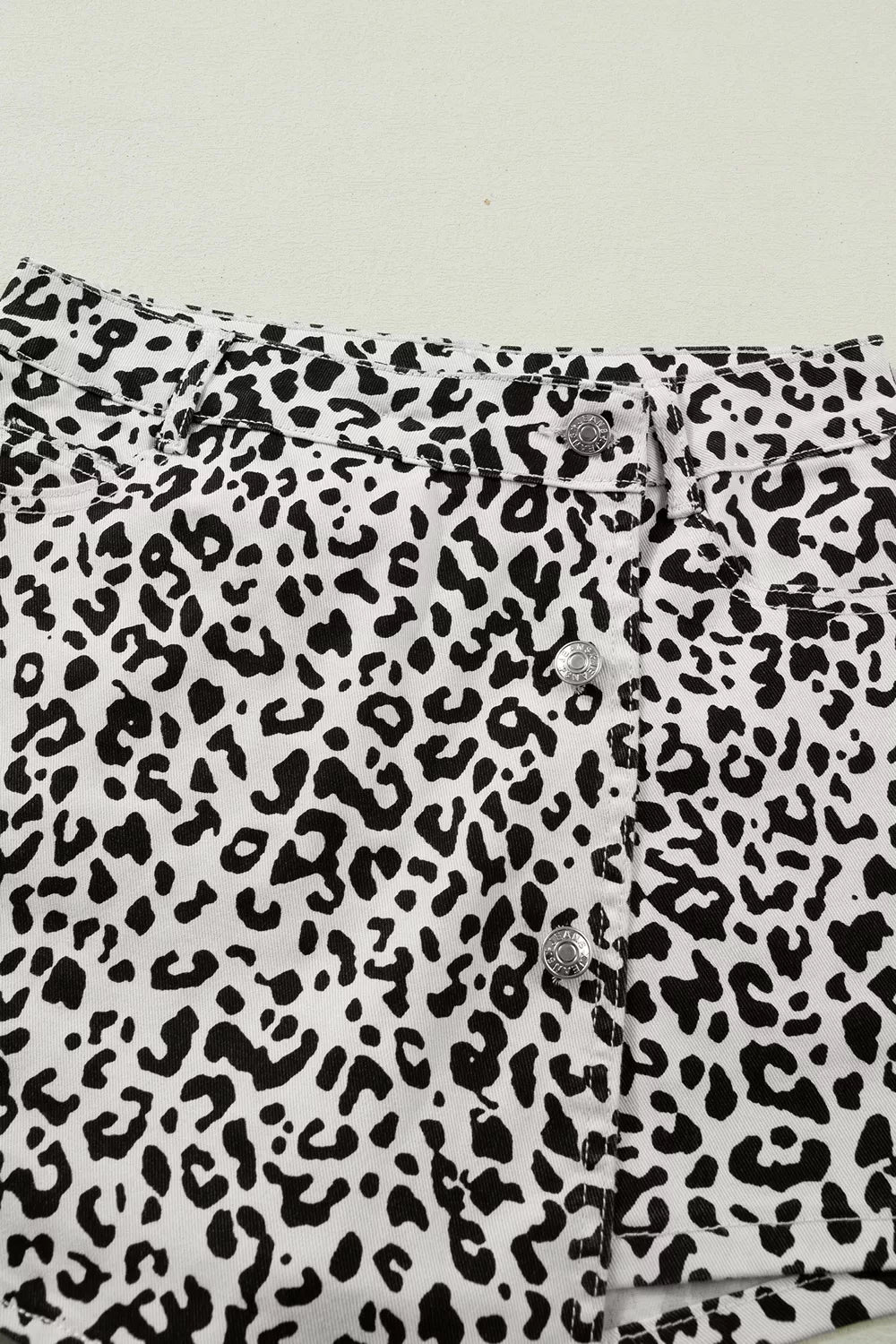 denim shorts in white with decorative button and mini