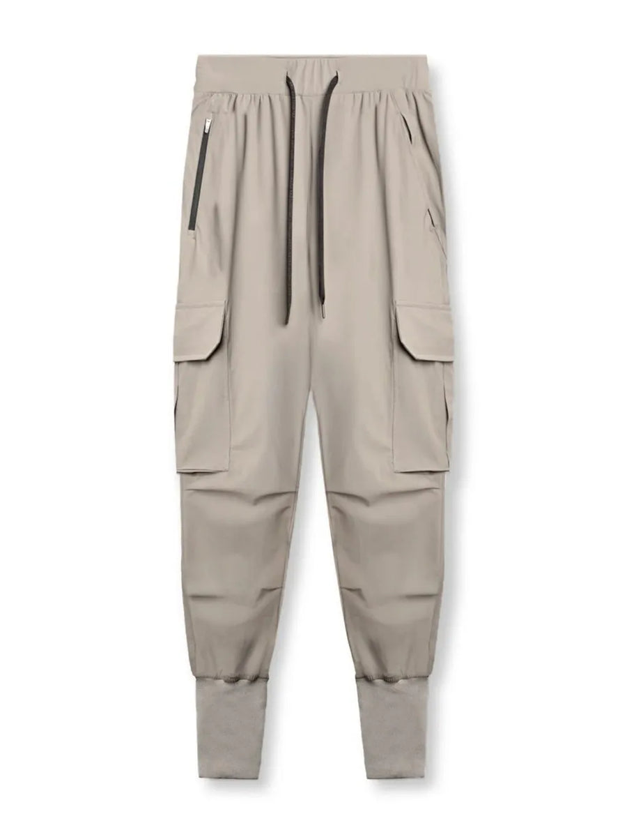 Technical cargo joggers in mocha with ribbed cuffs and zip pockets.