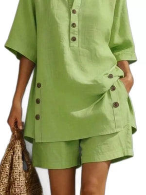 Green linen shorts with button detail and matching relaxed fit top.