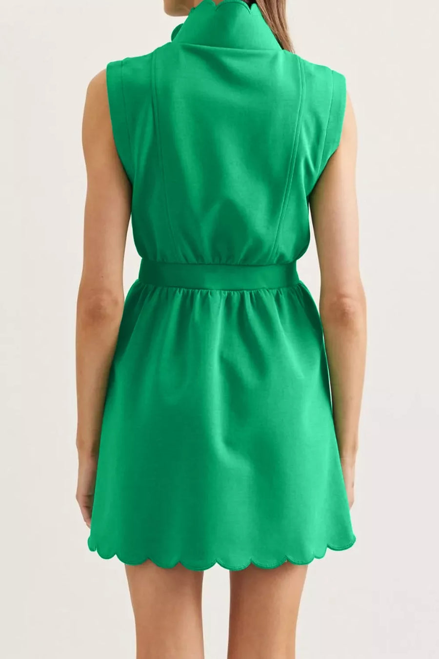 Green sleeveless mini dress with scalloped hem and high neck
