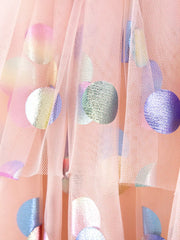 Pink tulle baby dress with iridescent polka dots and ruffled sleeves.