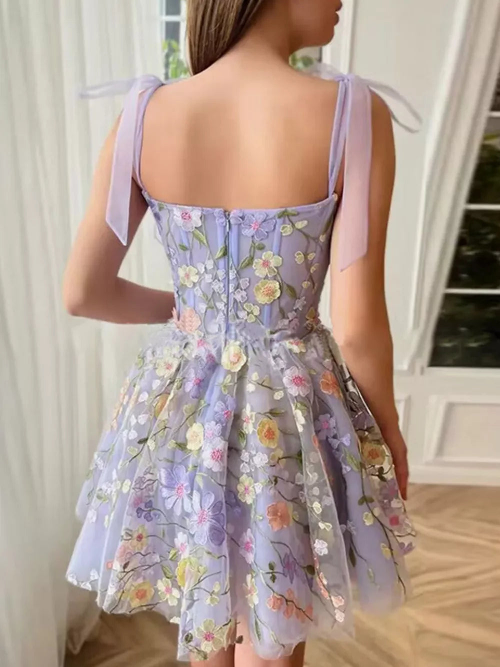 Floral embellished mini dress in lavender with tie straps and a full skirt.