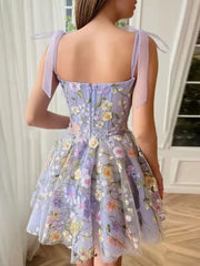 Floral embellished mini dress in lavender with tie straps and a full skirt.