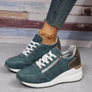 Dark green lace-up wedge sneakers with side zipper detail and white laces.