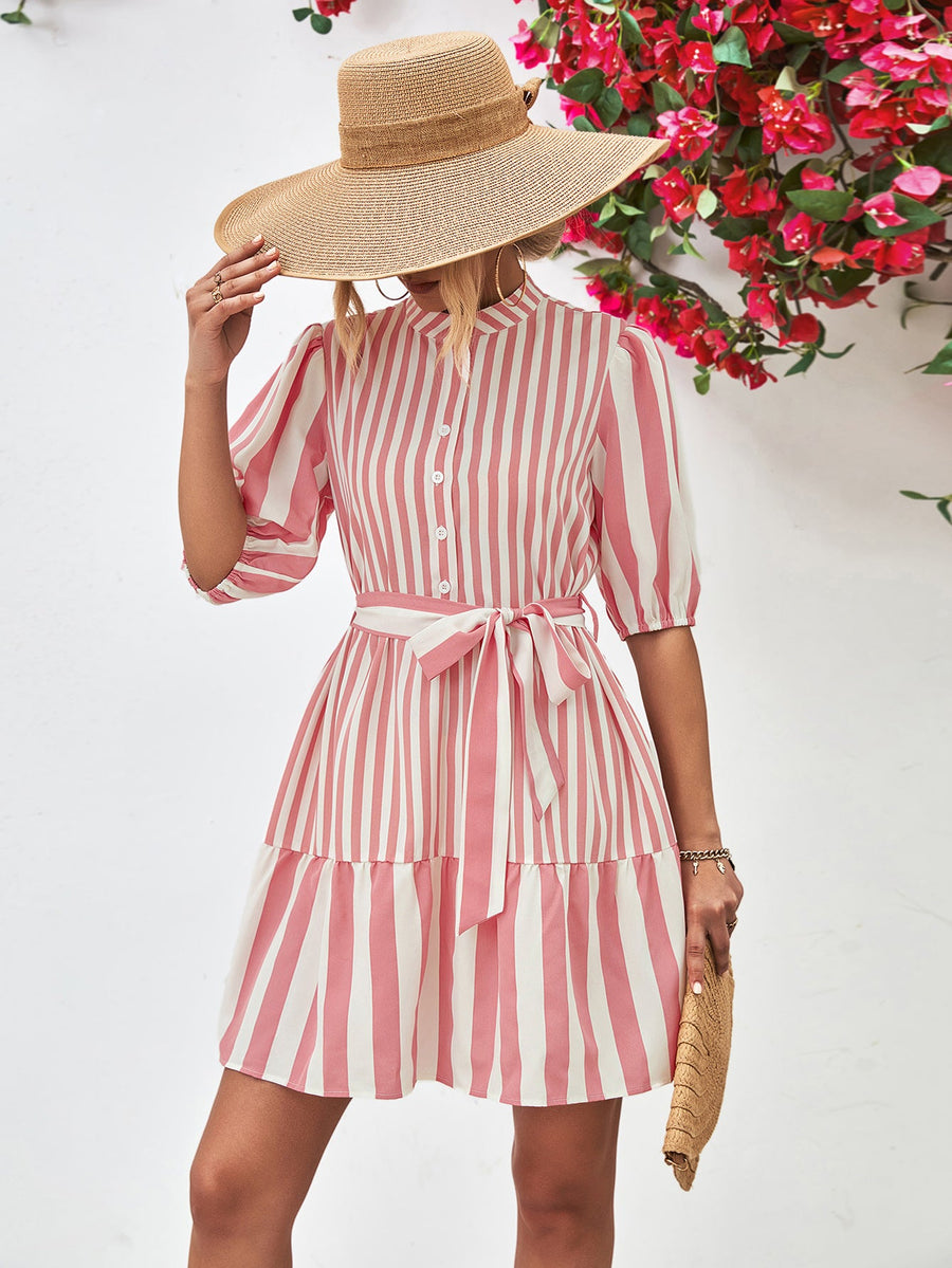 Blush pink and white striped shirred waist dress with puff sleeves and tiered skirt.
