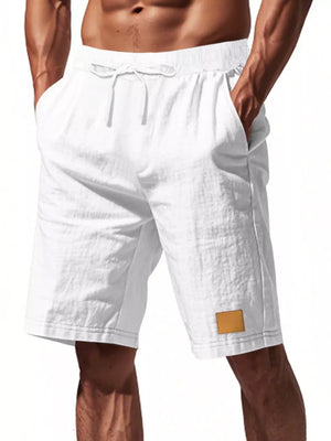White chino shorts with drawstring waist and leather patch detail