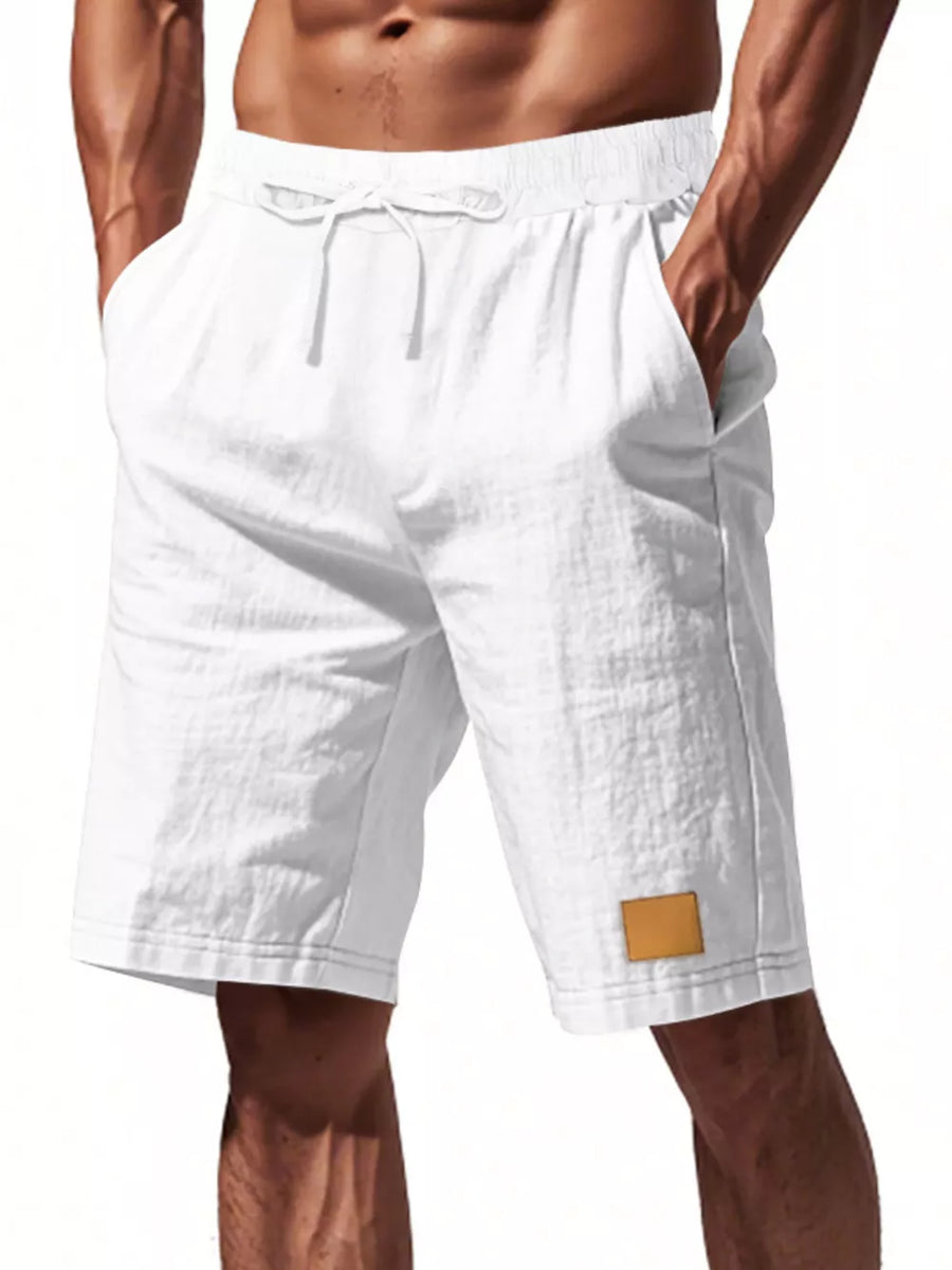 White chino shorts with drawstring waist and leather patch detail