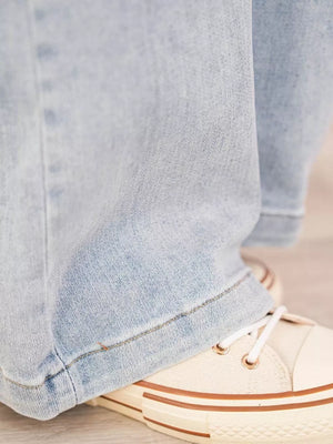 Light wash denim wide-leg cargo jeans with visible stitching detail.