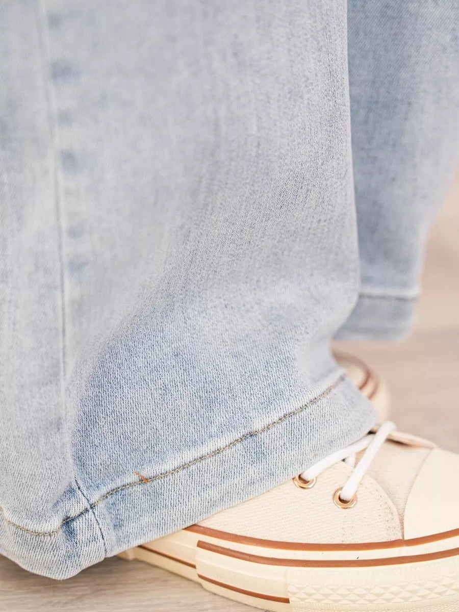 Light wash denim wide-leg cargo jeans with visible stitching detail.