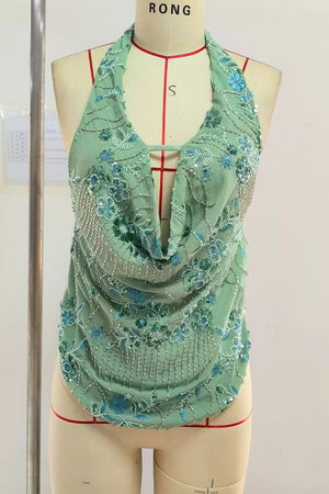 Mint green halter top with floral bead and sequin embellishments and a cowl neck.