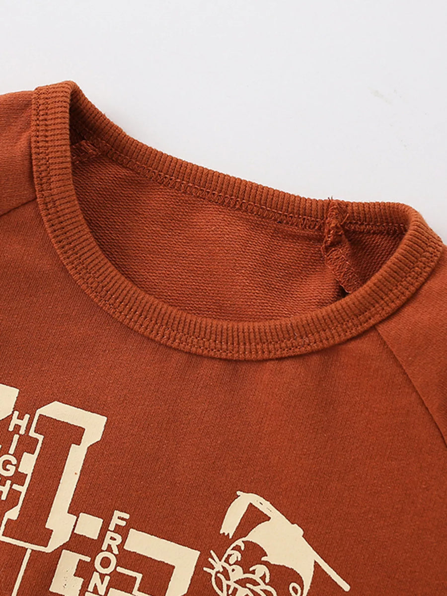 Rust cotton graphic sweatshirt with round neck and visible text detail.