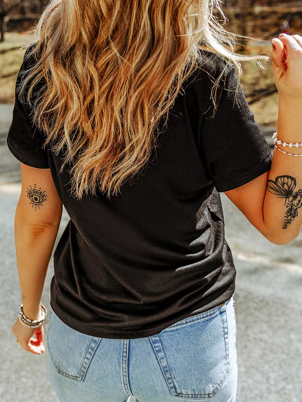 Black cotton t-shirt with short sleeves and a casual fit, featuring a graphic print on the front.