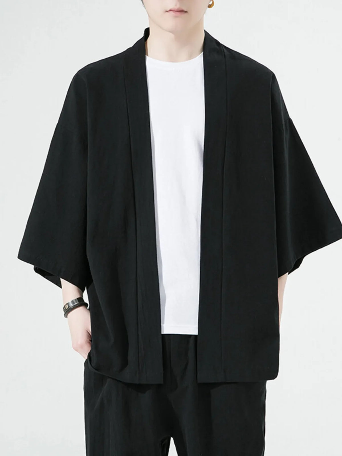 Black oversized casual open front jacket with short sleeves and a white t-shirt underneath.