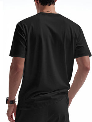 Black cotton t-shirt with textured fabric and short sleeves.