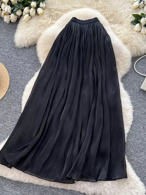 Black pleated maxi skirt with flowing fabric and a comfortable fit.