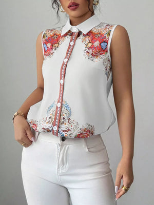 White sleeveless collared shirt with vibrant paisley print and button front.