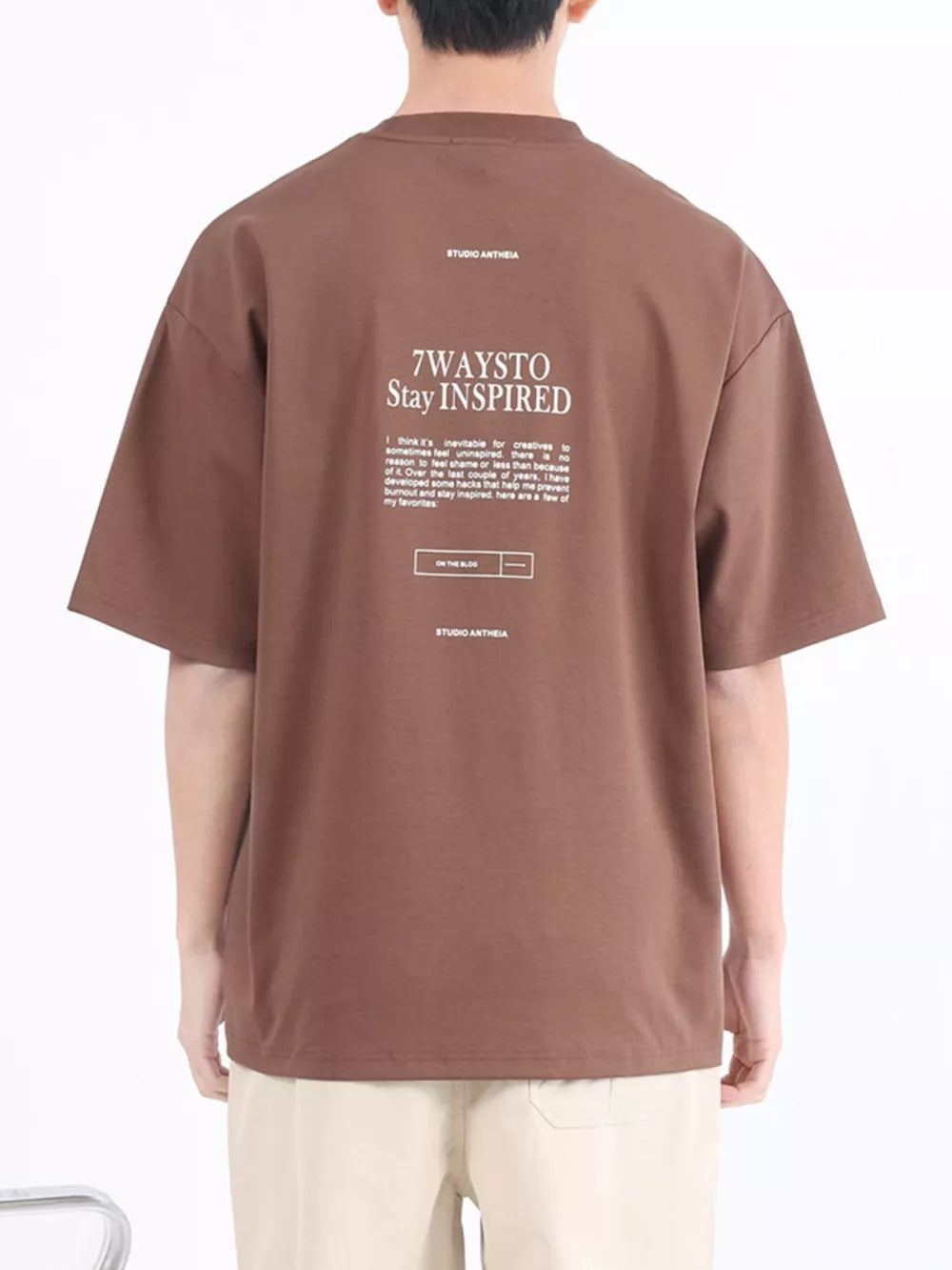 Brown cotton blend crew neck t-shirt with "7WAYSTO Stay INSPIRED" graphic on back.