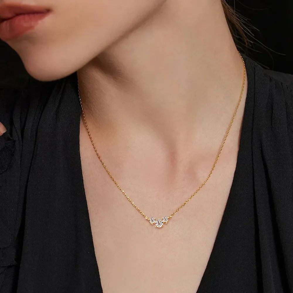 Gold cluster pendant necklace with moissanite stones on a delicate chain