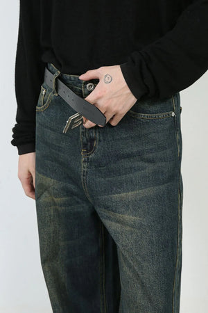 Faded denim wide-leg trousers in dark, with a relaxed fit and visible distressing.