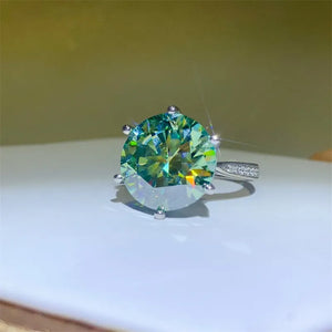 Silver ring with large green prismatic cut solitaire and small stones on band