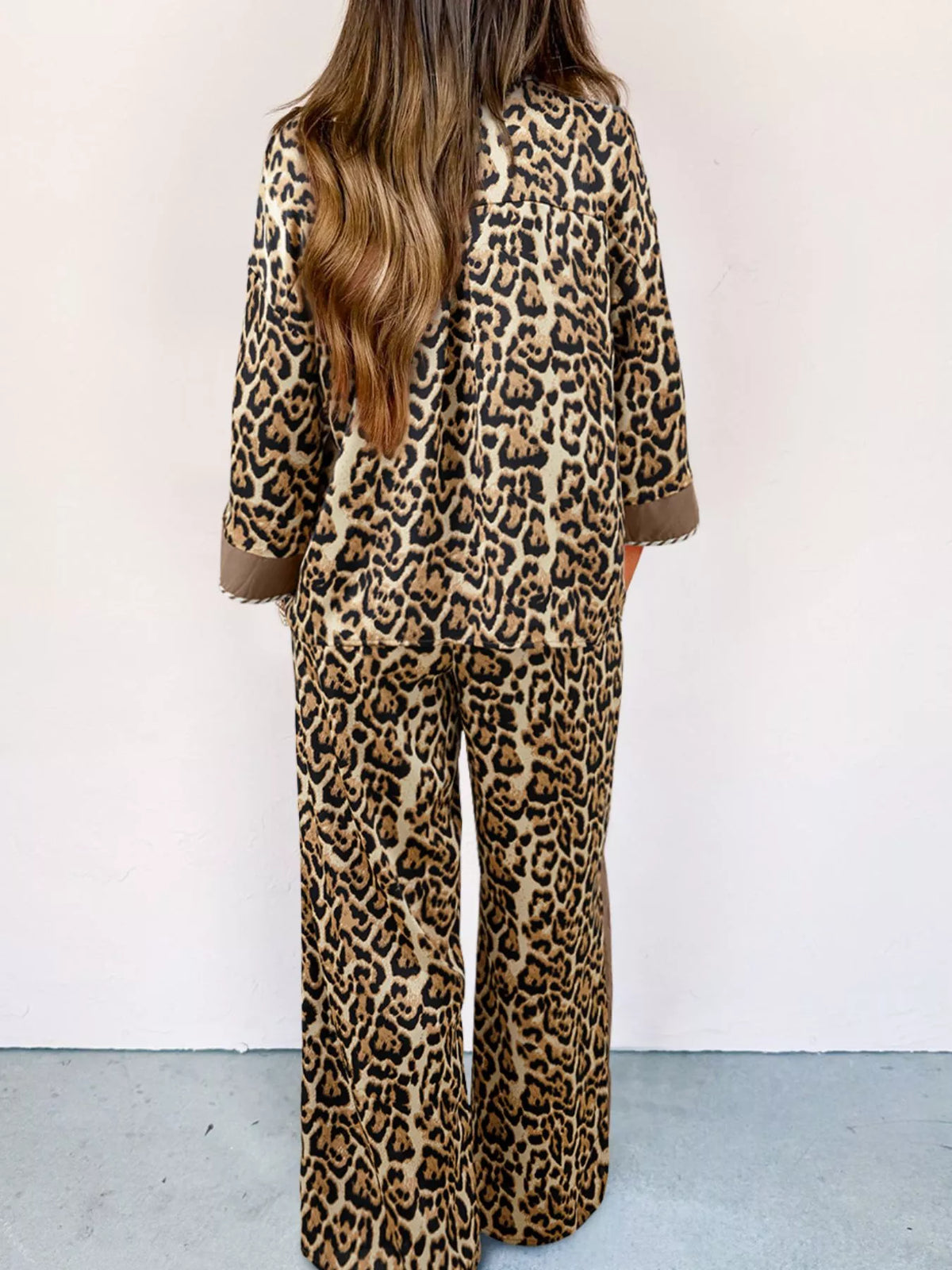 Chic leopard print two-piece set with buttoned shirt and wide-leg pants.