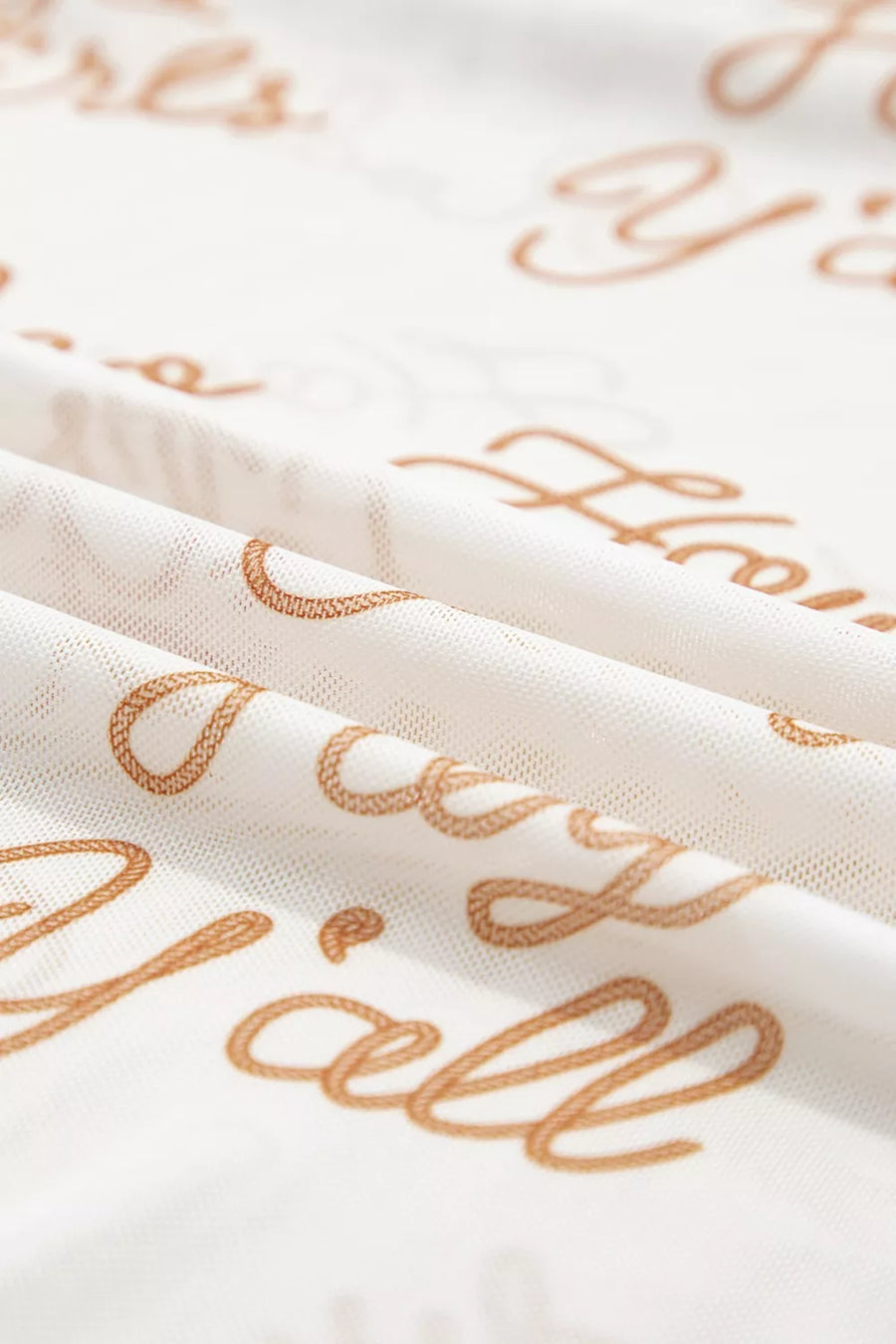 Sheer white high-neck shirt with all-over gold script text pattern.