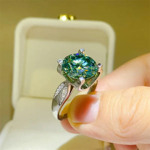Silver ring with large green moissanite solitaire and pave diamond band.