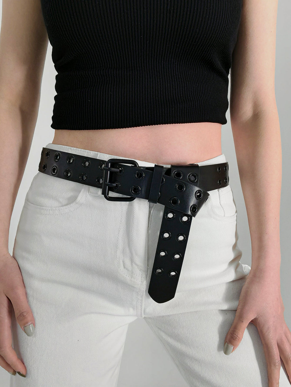 Black vegan leather belt with double grommet detail and silver buckle