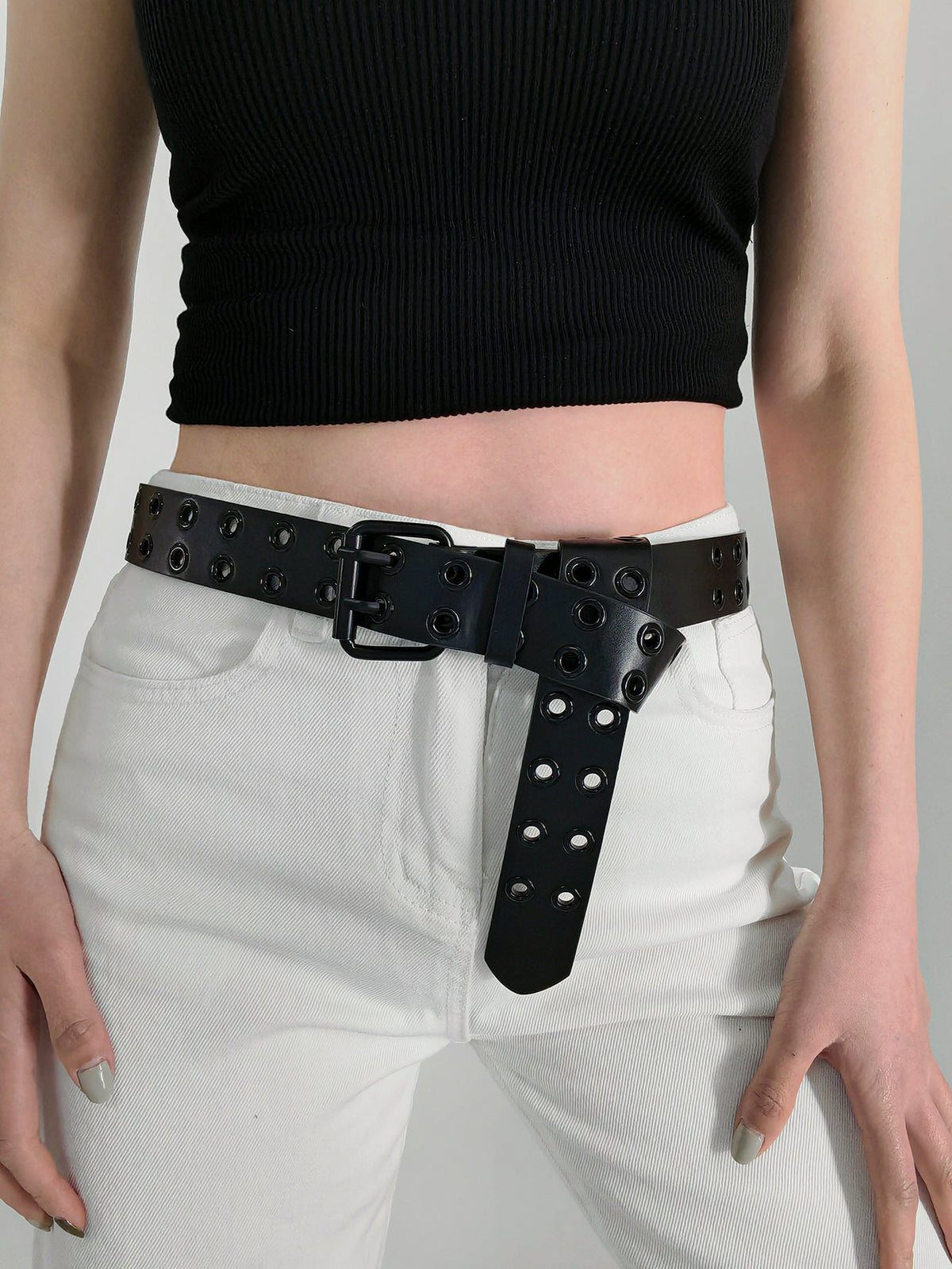 Black vegan leather belt with double grommet detail and silver buckle