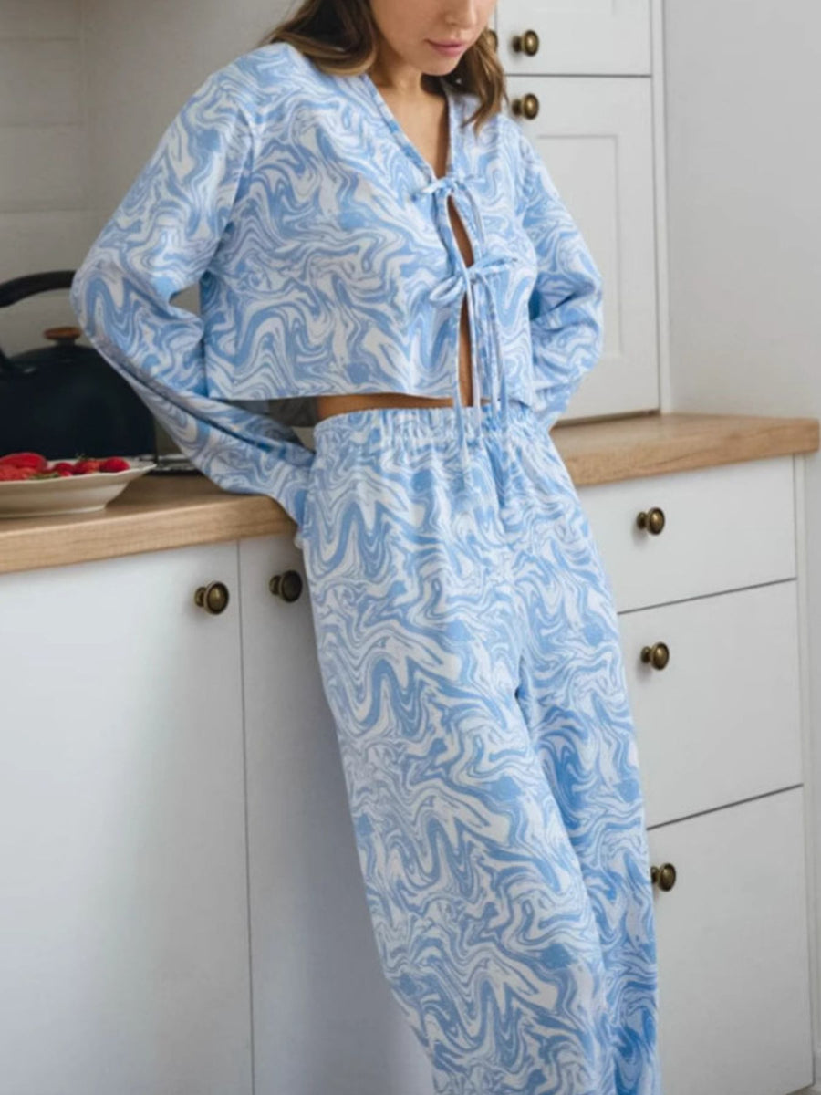 Lace-up lounge set with abstract blue and white pattern, cropped tie-front top and drawstring pants.