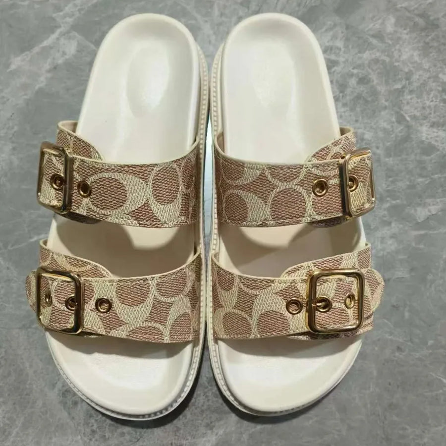 Buckle detail logo slide sandals in beige with double straps and gold hardware.