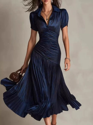 Navy blue striped midi dress with ruched bodice and pleated skirt.