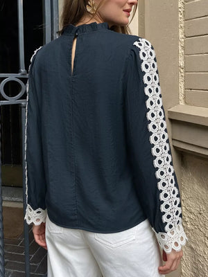 navy blue blouse with buttoned cuffs and long sleeve