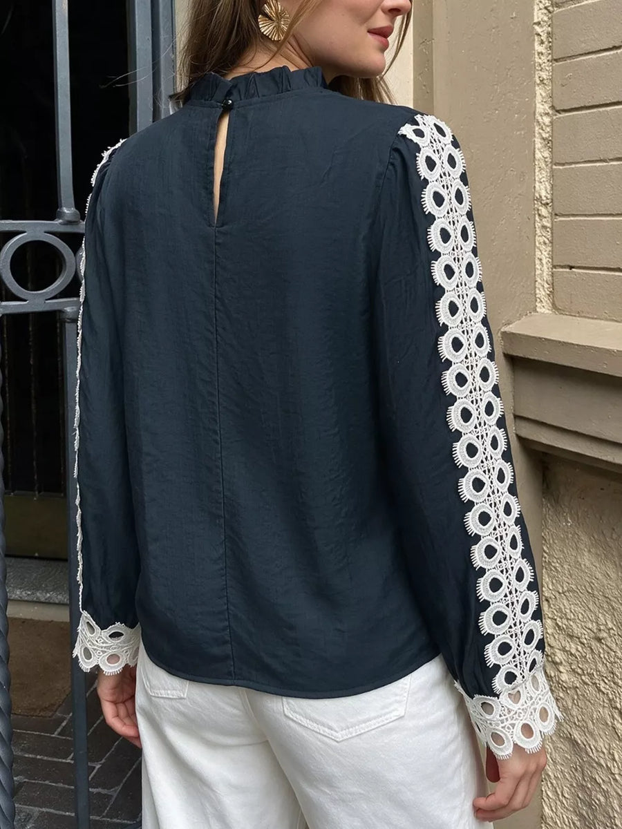 navy blue blouse with buttoned cuffs and long sleeve