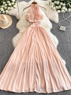 Pink pleated maxi dress with cutout details and halter neckline.