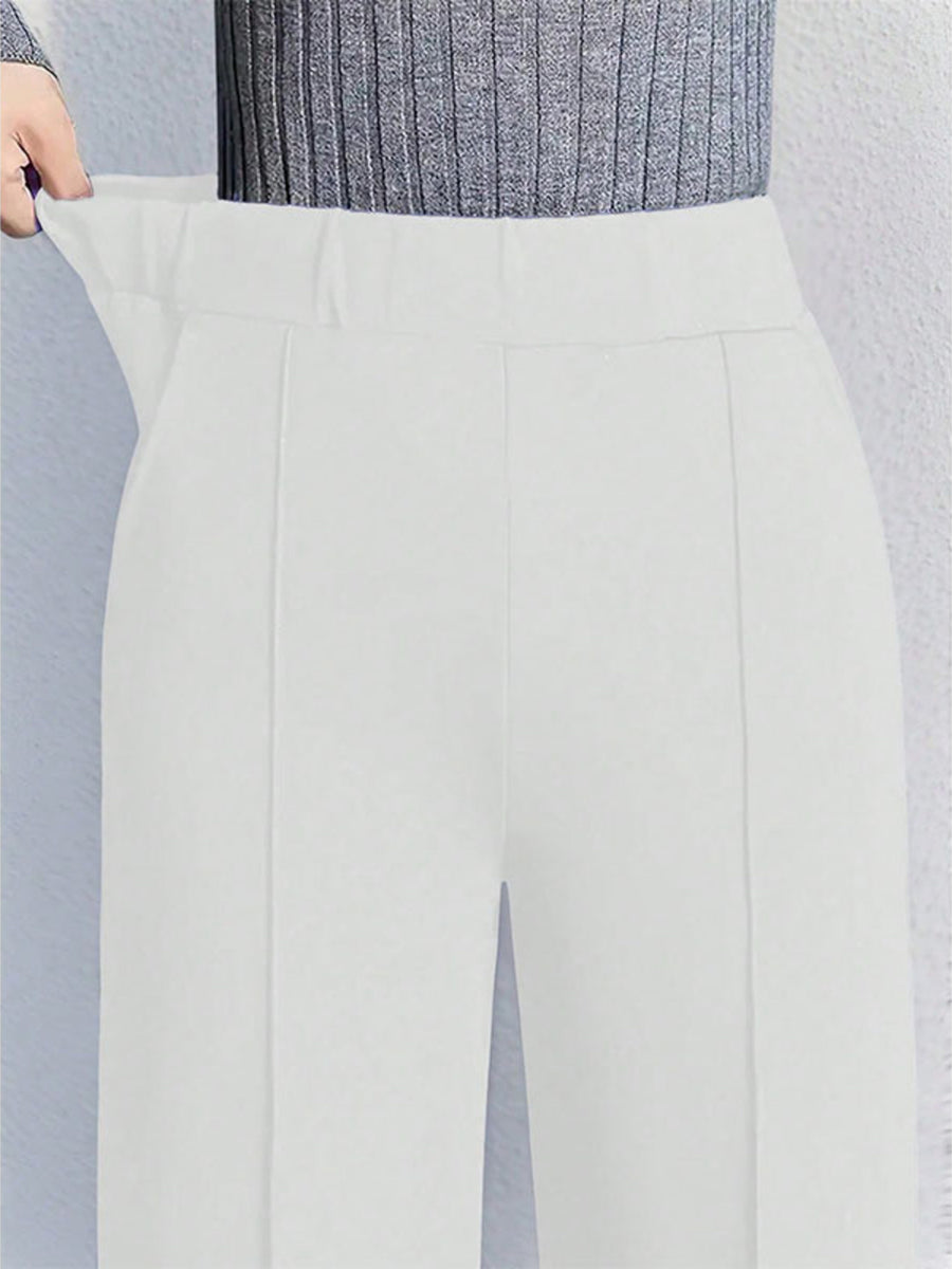 White high-waisted wide leg cotton trousers with pockets and a comfortable fit.