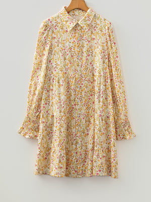 Floral print button-down shirt dress with tiered skirt and smocked cuffs.