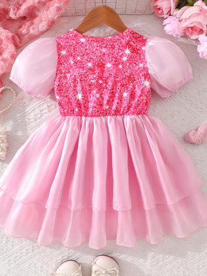 Pink baby dress with sequin bodice, puff sleeves, and tiered skirt