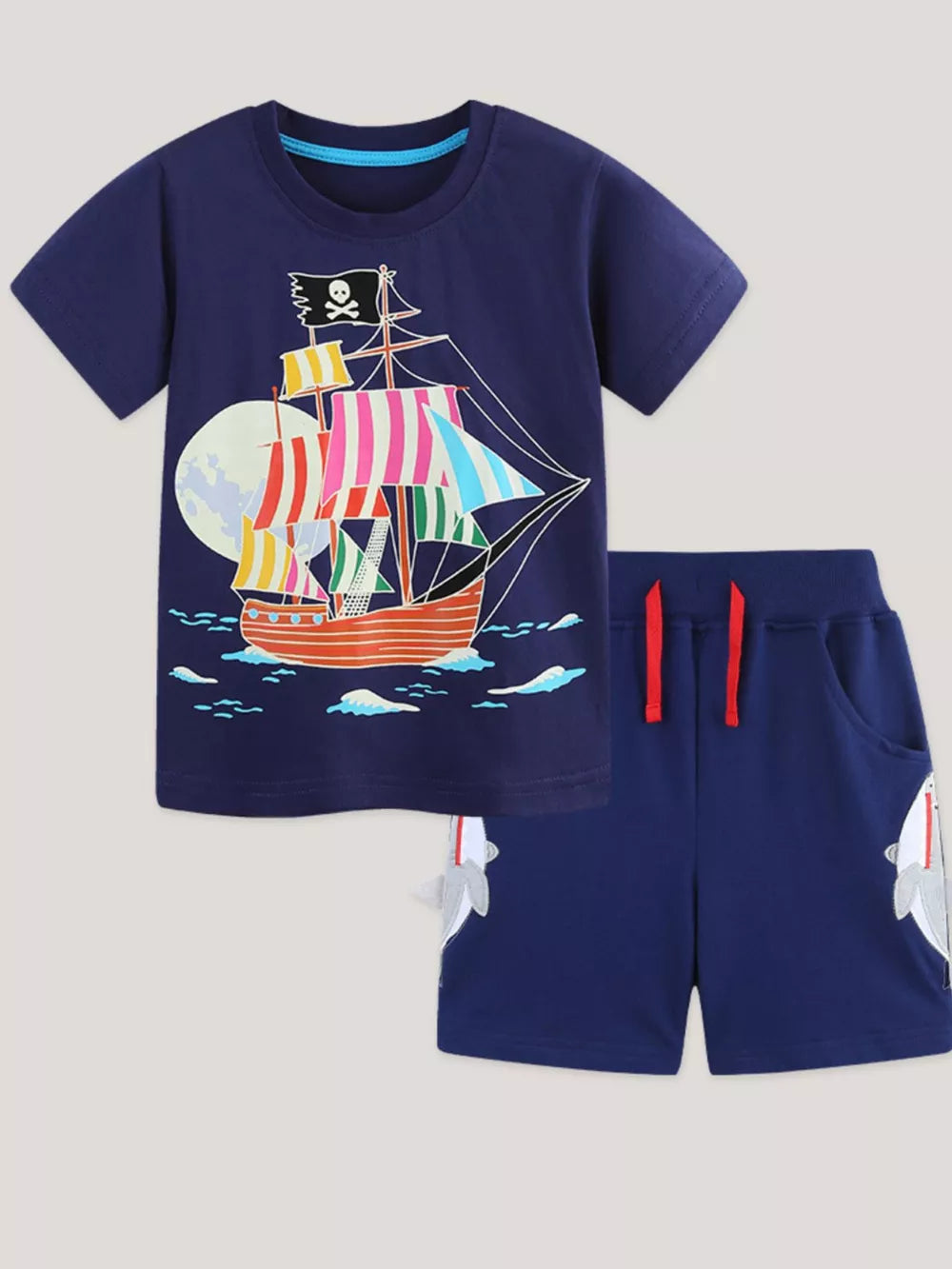 Navy cotton toddler boys' set with pirate ship graphic tee and shark applique shorts.