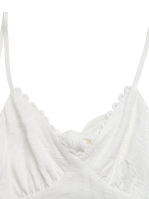 White lace tiered maxi dress with scalloped trim and a knot detail.